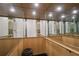 Interior view of a private elevator with mirrored walls and wooden handrails at 4348 Harborpointe Dr, Port Richey, FL 34668