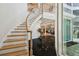 Grand entryway with a curved staircase, dark tile floors, and view to the home's open concept design at 4348 Harborpointe Dr, Port Richey, FL 34668