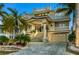 Elegant multi-story home boasts lush landscaping, a grand staircase, and a spacious two-car garage at 4348 Harborpointe Dr, Port Richey, FL 34668