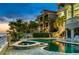 A luxurious waterfront estate with lush landscaping, a private pool, and stunning architecture, creating an idyllic oasis at 4348 Harborpointe Dr, Port Richey, FL 34668