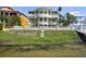 Stunning multi-story home with balconies, surrounded by lush landscaping on a waterfront lot at 4348 Harborpointe Dr, Port Richey, FL 34668