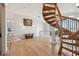 Elegant foyer featuring hardwood floors, a winding staircase, and refined decor at 4348 Harborpointe Dr, Port Richey, FL 34668
