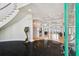 Luxury foyer with black marble flooring, grand staircase, and elegant lighting fixtures at 4348 Harborpointe Dr, Port Richey, FL 34668