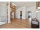 Open foyer with hardwood floors, a winding staircase, and an adjacent laundry room at 4348 Harborpointe Dr, Port Richey, FL 34668