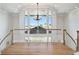 Open foyer with hardwood floors and railing overlooking neighborhood homes and palm trees at 4348 Harborpointe Dr, Port Richey, FL 34668