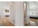 Hallway with hardwood floors leads to a bathroom and bedroom at 4348 Harborpointe Dr, Port Richey, FL 34668