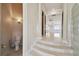 Hallway featuring stairs, tiled floors, columns, and a half bath at 4348 Harborpointe Dr, Port Richey, FL 34668