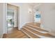 Well-lit hallway with hardwood floors and doorways, leading to other areas of the house at 4348 Harborpointe Dr, Port Richey, FL 34668