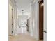 Bright hallway featuring tiled floors, columns, and doors that lead to the exterior at 4348 Harborpointe Dr, Port Richey, FL 34668