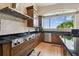 This kitchen features stainless steel appliances, granite countertops, and a large window with outdoor views at 4348 Harborpointe Dr, Port Richey, FL 34668