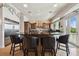 This modern kitchen includes a large island with seating and views of the outside at 4348 Harborpointe Dr, Port Richey, FL 34668