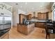 A kitchen with wood cabinetry, granite countertops, and a large island, perfect for cooking at 4348 Harborpointe Dr, Port Richey, FL 34668