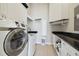 Well-organized laundry room with modern appliances, granite countertops, and ample storage space at 4348 Harborpointe Dr, Port Richey, FL 34668