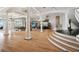 Spacious living room with hardwood floors, stately columns, and panoramic water views at 4348 Harborpointe Dr, Port Richey, FL 34668