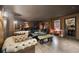 This stylish living room showcases dark wood accents, comfortable seating, and a bar for relaxation and entertainment at 4348 Harborpointe Dr, Port Richey, FL 34668