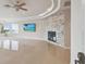 Spacious living room featuring a stone fireplace, recessed lighting, and large windows with a tropical view at 4348 Harborpointe Dr, Port Richey, FL 34668