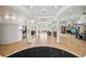Expansive living room featuring elegant columns, light hardwood floors, built-in shelving, and access to an outdoor patio at 4348 Harborpointe Dr, Port Richey, FL 34668