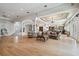 Open concept living area with hardwood floors, large windows, and views of the foyer, kitchen and wet bar at 4348 Harborpointe Dr, Port Richey, FL 34668