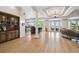 Open living area with a built-in bar, hardwood floors, and large windows offering water views at 4348 Harborpointe Dr, Port Richey, FL 34668