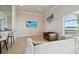 Living room featuring modern sofas, accent chair, ocean view windows, and TV at 4348 Harborpointe Dr, Port Richey, FL 34668