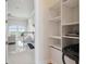 Walk-in pantry with white shelving and living room view featuring ocean at 4348 Harborpointe Dr, Port Richey, FL 34668
