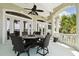 Covered outdoor dining patio features a ceiling fan and expansive water views at 4348 Harborpointe Dr, Port Richey, FL 34668