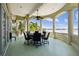 Covered outdoor patio with dining set and views of water at 4348 Harborpointe Dr, Port Richey, FL 34668