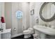 Quaint powder room with pedestal sink, round window, and striped walls at 4348 Harborpointe Dr, Port Richey, FL 34668