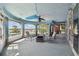 Enclosed sunroom with panoramic views, pool access, and a charming seating area at 4348 Harborpointe Dr, Port Richey, FL 34668