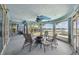 Bright sunroom with a decorative ceiling fan and views of the waterfront at 4348 Harborpointe Dr, Port Richey, FL 34668