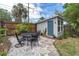 Backyard with a patio featuring outdoor seating, a shed, and landscaping, ideal for enjoying the outdoors at 435 11Th N Ave, St Petersburg, FL 33701