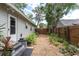Lush backyard featuring a well-maintained lawn, mature trees, and wood fencing, creating a private outdoor oasis at 435 11Th N Ave, St Petersburg, FL 33701