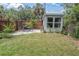 Well-manicured backyard featuring a grassy lawn, patio with outdoor seating, and landscaping, perfect for relaxation and entertaining at 435 11Th N Ave, St Petersburg, FL 33701