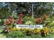Sign for Crescent Lake Park surrounded by vibrant red, yellow, and green plants at 435 11Th N Ave, St Petersburg, FL 33701