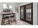 Hallway nook featuring black french doors and breakfast bar with stools by a window at 435 11Th N Ave, St Petersburg, FL 33701