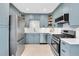 Modern kitchen with stainless steel appliances, light blue cabinetry, and white countertops and backsplash at 435 11Th N Ave, St Petersburg, FL 33701