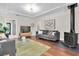 Bright living room featuring hardwood floors, a modern fireplace, coffered ceilings, and a comfortable seating area at 435 11Th N Ave, St Petersburg, FL 33701
