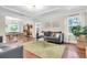 Open-concept living space featuring hardwood floors, coffered ceilings, and a dining area with natural light at 435 11Th N Ave, St Petersburg, FL 33701