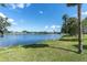 Expansive waterfront view showcases tranquil lake waters and a distant skyline, framed by lush green shoreline at 435 11Th N Ave, St Petersburg, FL 33701