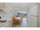 Eat-in kitchen with dining table and chairs; sliding glass doors lead to outdoor patio at 4575 Whitton Way # 1132, New Port Richey, FL 34653