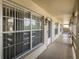 Exterior walkway featuring unit entry, neutral paint, and well maintained community area at 4575 Whitton Way # 1132, New Port Richey, FL 34653