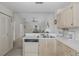 Kitchen featuring white countertops and cabinets; eat-in kitchen overlooks living room at 4575 Whitton Way # 1132, New Port Richey, FL 34653