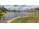 Scenic lake view surrounded by lush greenery and waterfront properties in a quiet community at 4575 Whitton Way # 1132, New Port Richey, FL 34653