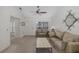 Cozy living room with neutral carpet, ceiling fan, natural light, and comfortable seating at 4575 Whitton Way # 1132, New Port Richey, FL 34653