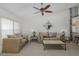 Inviting living room featuring carpet, a ceiling fan, an accent mirror, and comfortable neutral seating at 4575 Whitton Way # 1132, New Port Richey, FL 34653