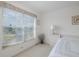 Bedroom with a large window overlooking the lake, bright neutral walls, and carpet at 4575 Whitton Way # 1132, New Port Richey, FL 34653