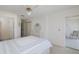 Bedroom with neutral walls, carpet, and access to an ensuite bathroom and balcony at 4575 Whitton Way # 1132, New Port Richey, FL 34653