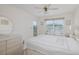 Bright bedroom featuring a ceiling fan, neutral walls, and sliding glass doors to a balcony at 4575 Whitton Way # 1132, New Port Richey, FL 34653