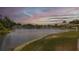 Scenic pond view at sunset, surrounded by lush landscaping and beautiful homes at 4575 Whitton Way # 1132, New Port Richey, FL 34653