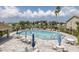 Beautiful community pool and lounge area with lake views and ample seating at 4575 Whitton Way # 1132, New Port Richey, FL 34653